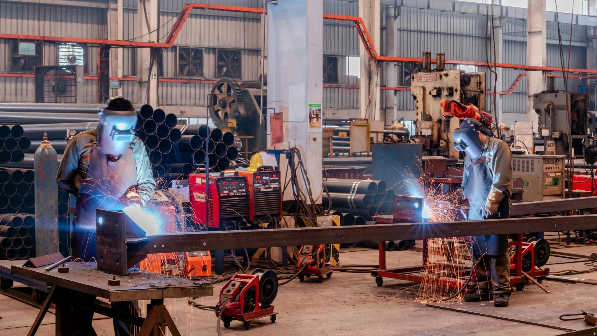 Two factory workers welding