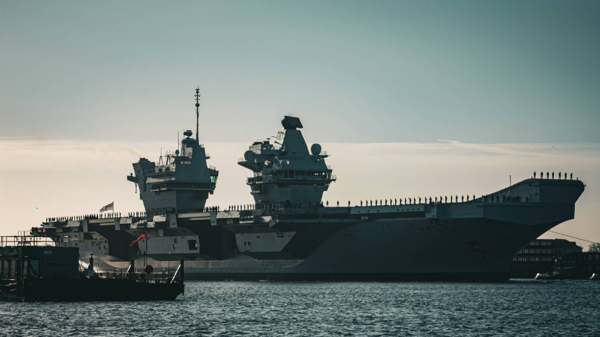 Aircraft carrier docked at harbour.
