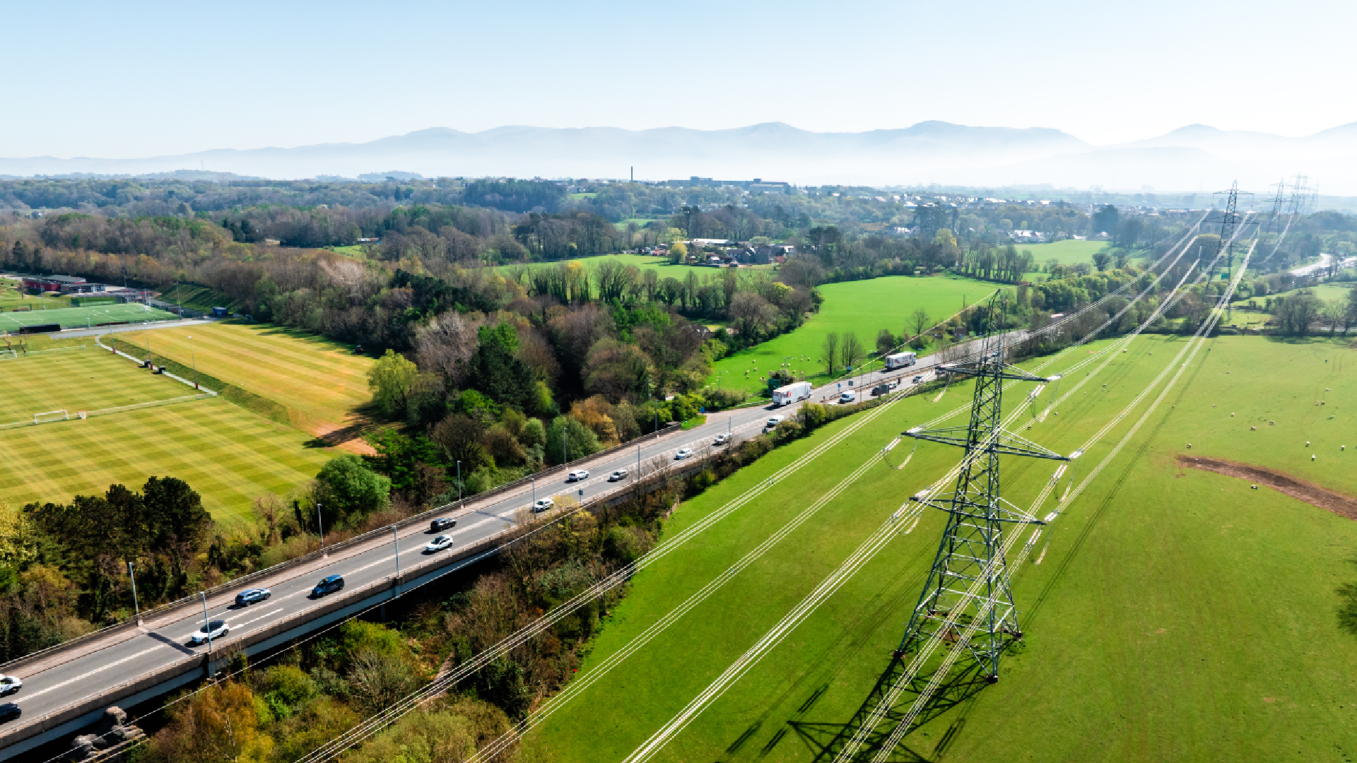 Field with a road and pylons